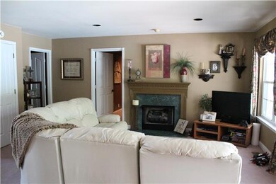 The Living Room is the focal point open to the kitchen & dining rooms offering a marble fireplace and double windows showcasing the view of the inground pool