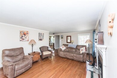 This cozy living room features neutral paint, hard