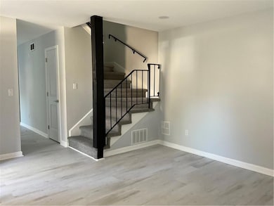 Staircase with wood finished floors and baseboards