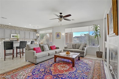 Living area with ceiling fan, recessed lighting, a