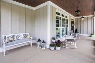Roomy front porch with space for rocking chairs or outdoor seating.