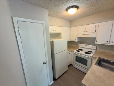 Kitchen with white appliances, under cabinet rang
