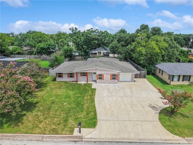 Ranch-style house featuring massive, expanded driv
