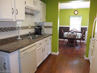 Updated kitchen with tile backsplash, new flooring and lots of cabinet space.