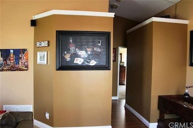 View of the hallway from the living room, with mas