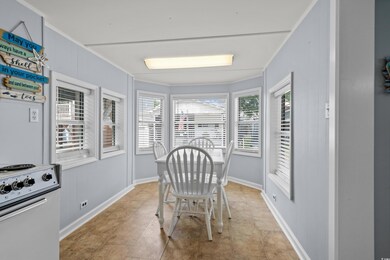 Dining room with ornamental molding and baseboards