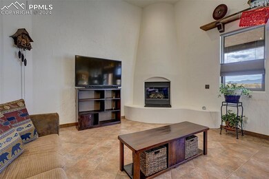 Tiled living room featuring a fireplace and a towe