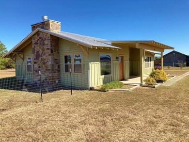 Rear view of house featuring a yard