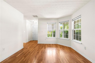 Spare room featuring wood finished floors and baseboards