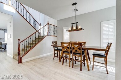 Dining space with light wood-type flooring, stairw