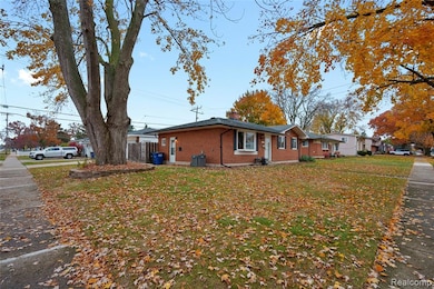 View of property exterior featuring brick siding, a yard, and a chimney