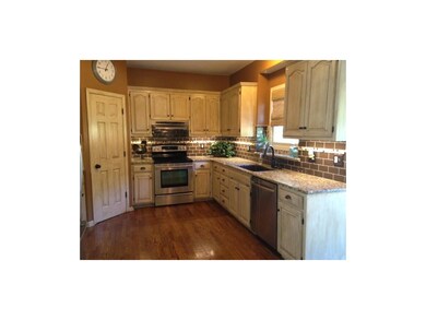 Newly stained hardwoods and glazed cabinets