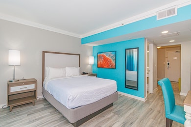 Bedroom with crown molding and light hardwood / wo