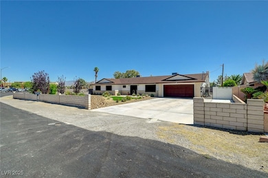 Ranch-style home featuring an attached garage and concrete driveway