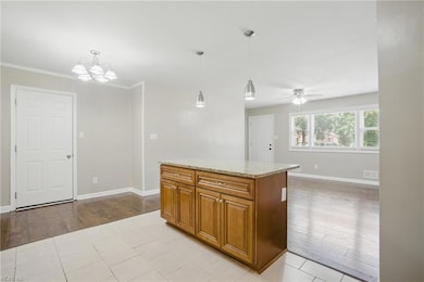 Kitchen island view to living room and side door to garage