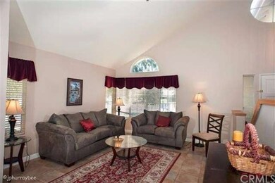 Lovely living room with vaulted ceilings. Light an
