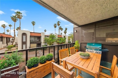 Balcony featuring area for grilling and a resident
