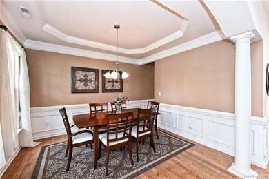 Formal dining showcases hardwoods, picture molding