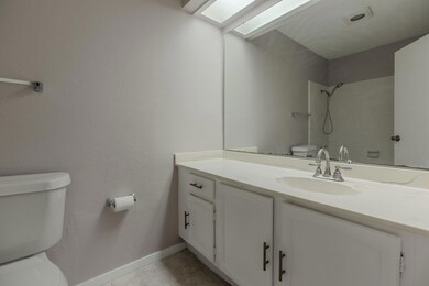 Bathroom with tile patterned flooring, toilet, orn