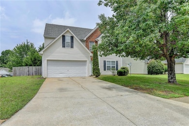 Traditional home with concrete driveway, roof with
