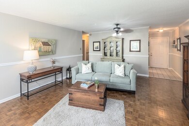 Living room featuring dark parquet flooring and ce