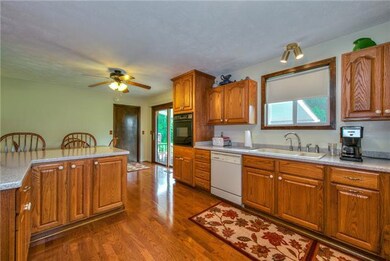 Built in appliances and hardwood floors add to the kitchen