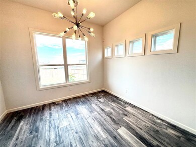 Unfurnished dining area featuring dark wood finished floors and a chandelier