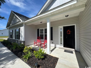 Entrance to property with a porch and board and batten siding