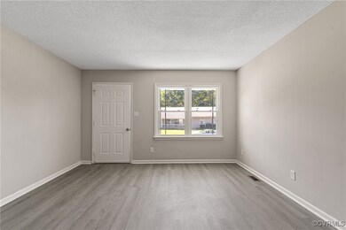 Unfurnished room featuring a textured ceiling and