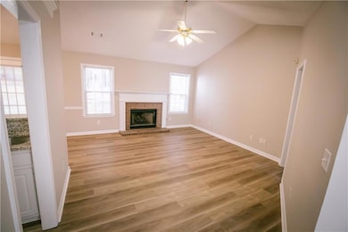 The living room features new flooring, a wealth of
