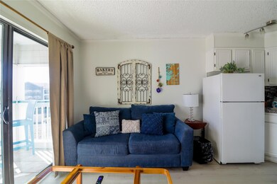 Living room featuring light wood-style floors and a textured ceiling