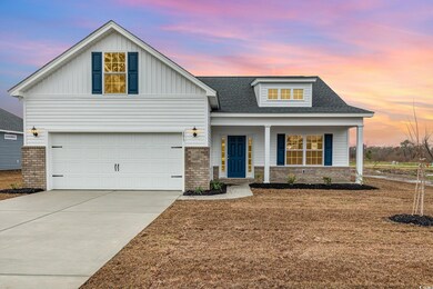 Modern inspired farmhouse with driveway, covered porch, brick siding, and board and batten siding
