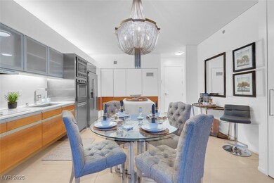 Dining area featuring a chandelier and light tile