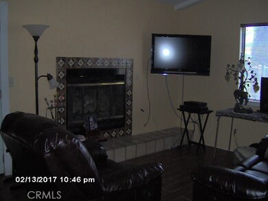 Gaslog Fireplace and wood styled tile in family room