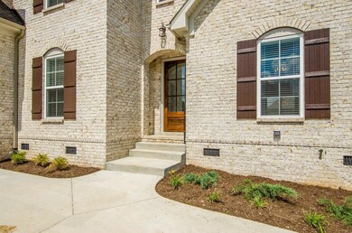Mostly Brick Exterior with courtyard driveway and side entry 2 car garage. These are not actual pictures of home under construction