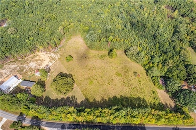 Aerial overview of property's location featuring a heavily wooded area