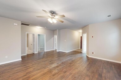 Spare room featuring ceiling fan and hardwood / wo