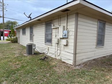 View of home's exterior featuring a yard and a cooling unit