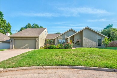 Mid-century home featuring brick siding, a garage, and driveway