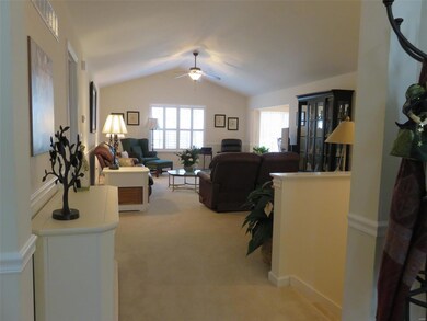 View of Great Room from foyer...could also be utilized as living/dining room combination...your choice! Custom plantation shutters throughout the home.