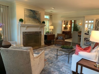 Living room with wood-type flooring, a fireplace, 