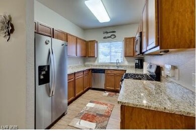 Kitchen featuring stainless steel appliances, a si