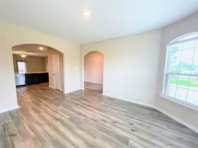 Unfurnished room featuring arched walkways, light 