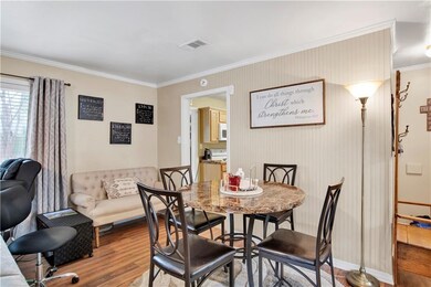 Dining space featuring ornamental molding and hard