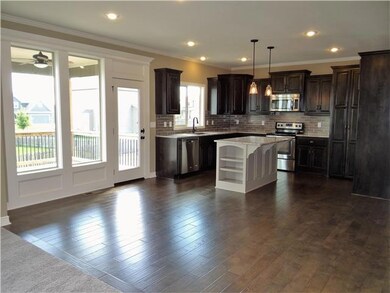 Spacious kitchen with hard wood flooring, center i