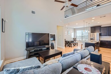 Living area with light wood-style floors, a high 