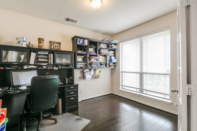 The large study where hardwood floors continue and large double windows sits just to the right off the foyer.
