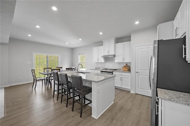 The kitchen is highlighted by granite counters, ample cabinets, large pantry and stainless steel appliances.