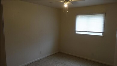 Spare room with a ceiling fan, baseboards, and lig