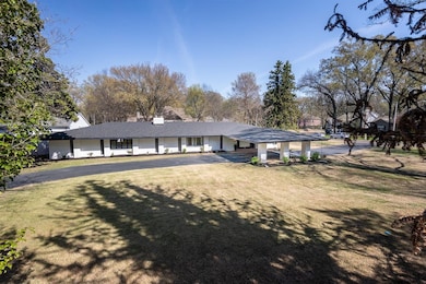 Ranch-style house with a chimney and a front yard